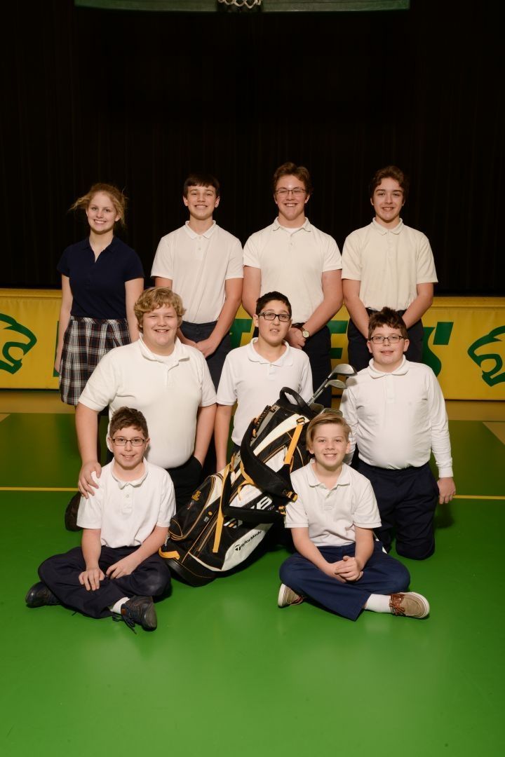 A group of children posing for a picture with a golf bag