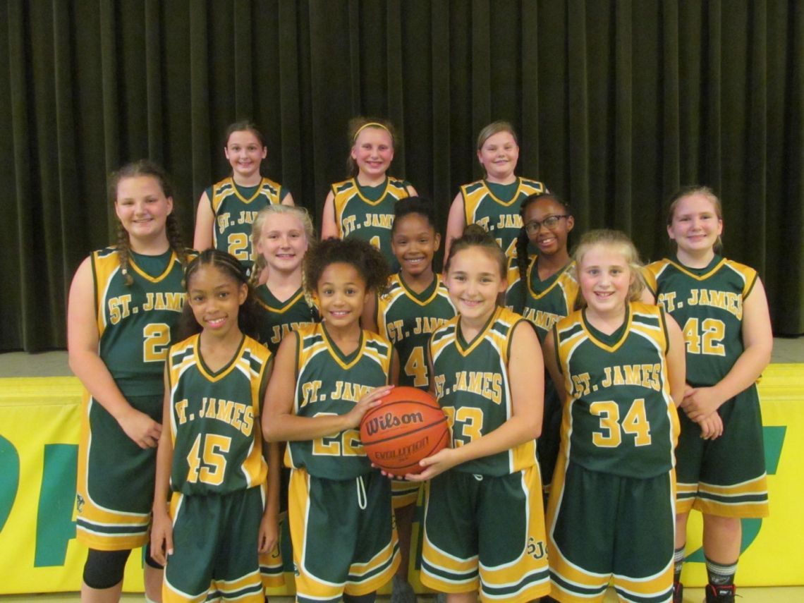 A group of girls in st. james uniforms pose for a picture