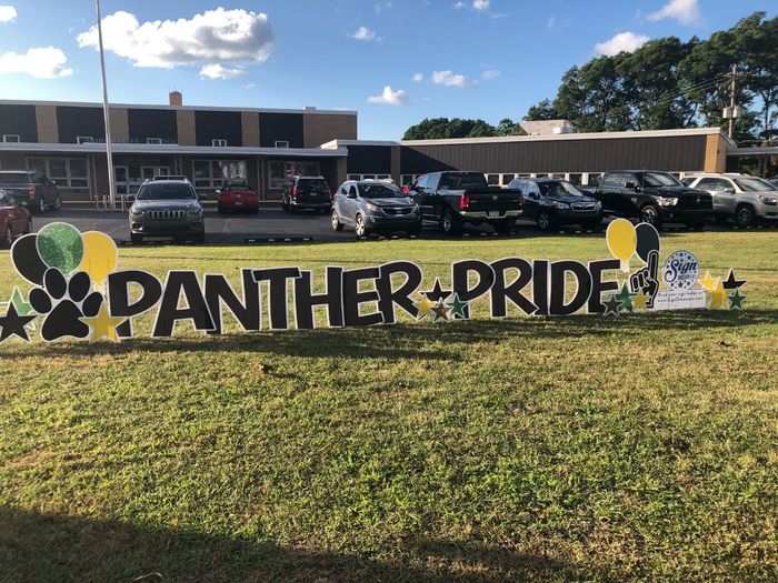 A panther pride sign in front of a school