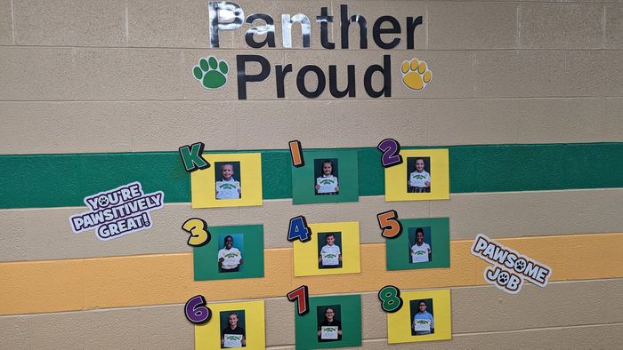 A panther proud bulletin board with pictures on it