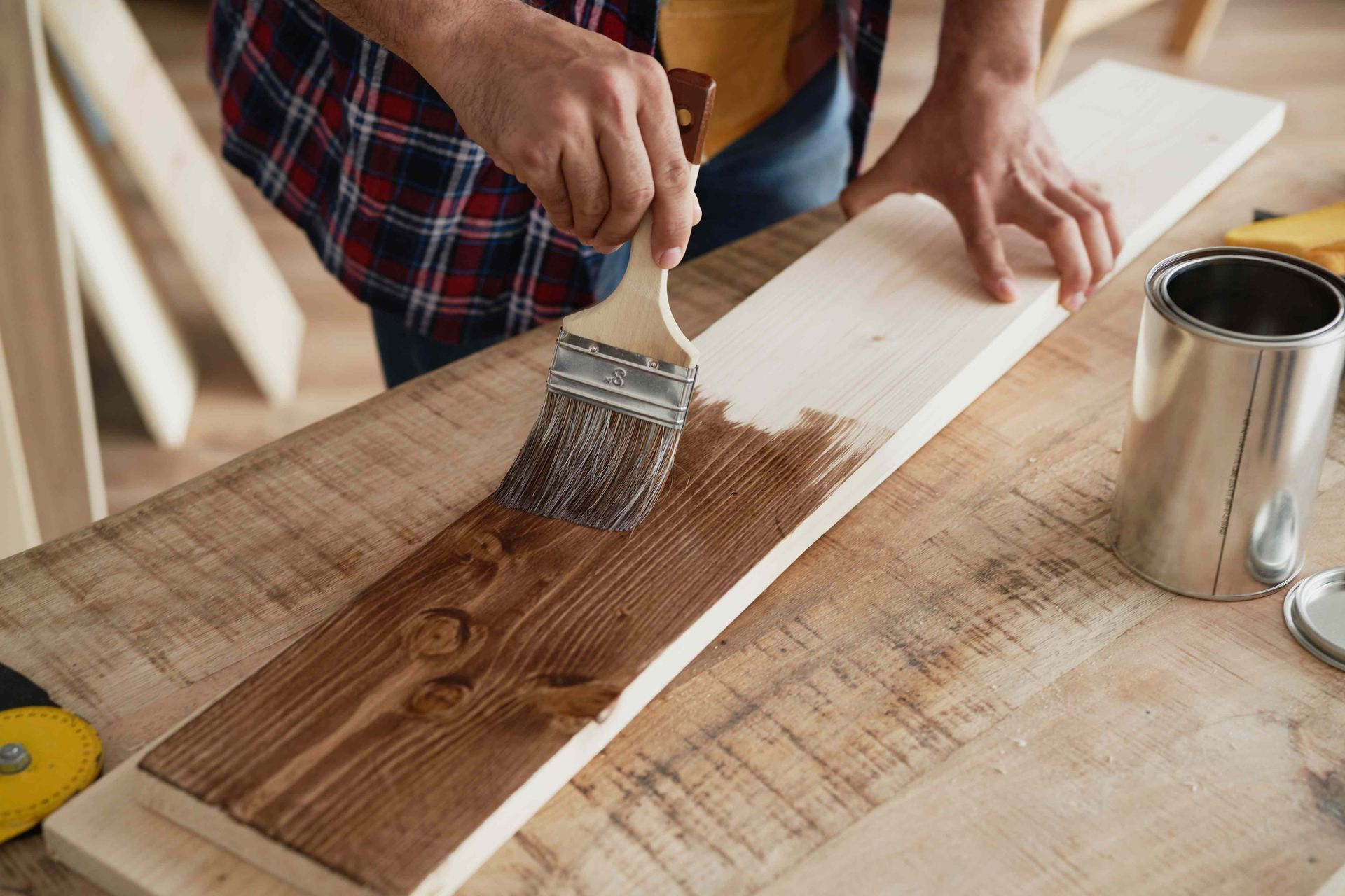 A man painting a board