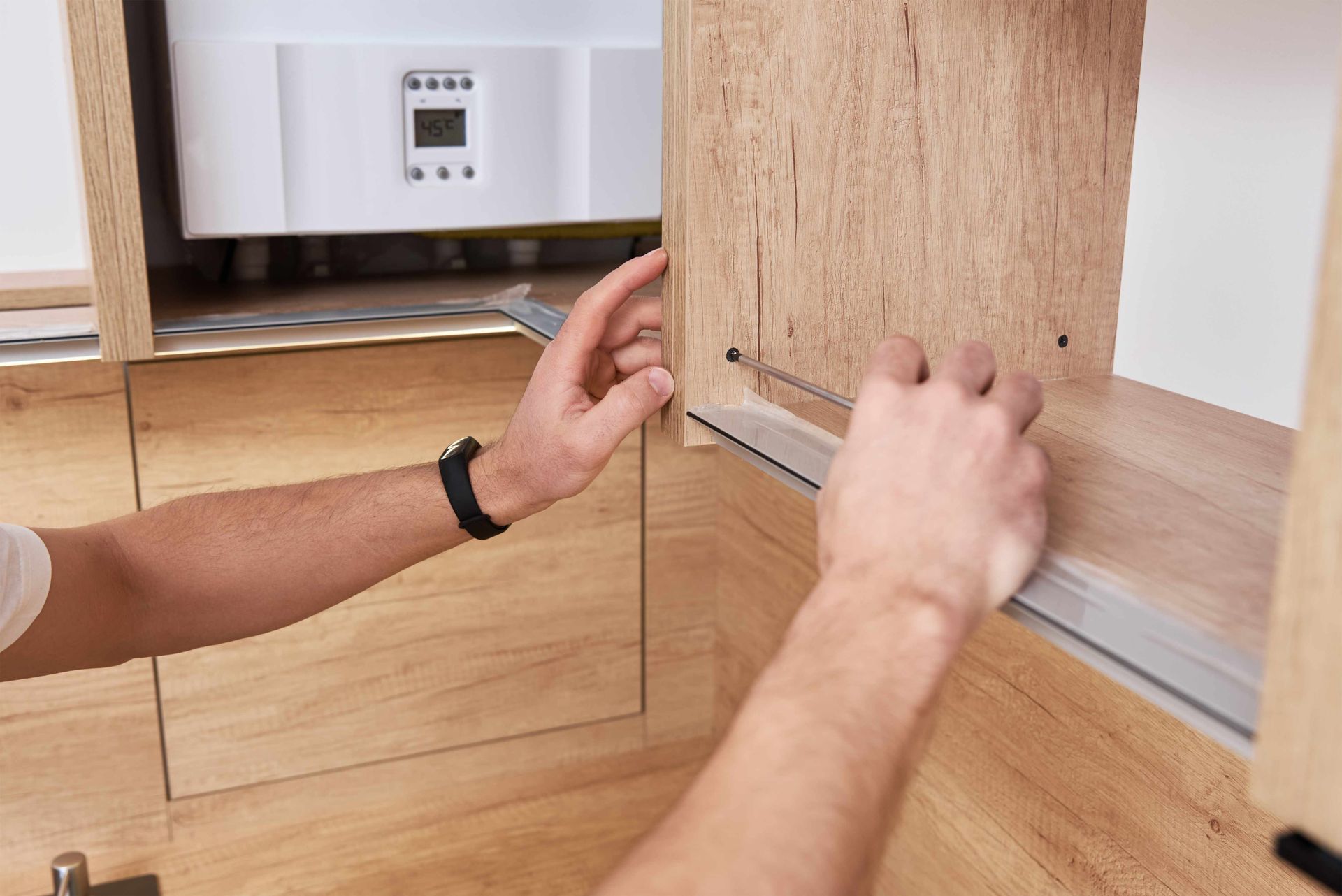 Man installing cabinet doors