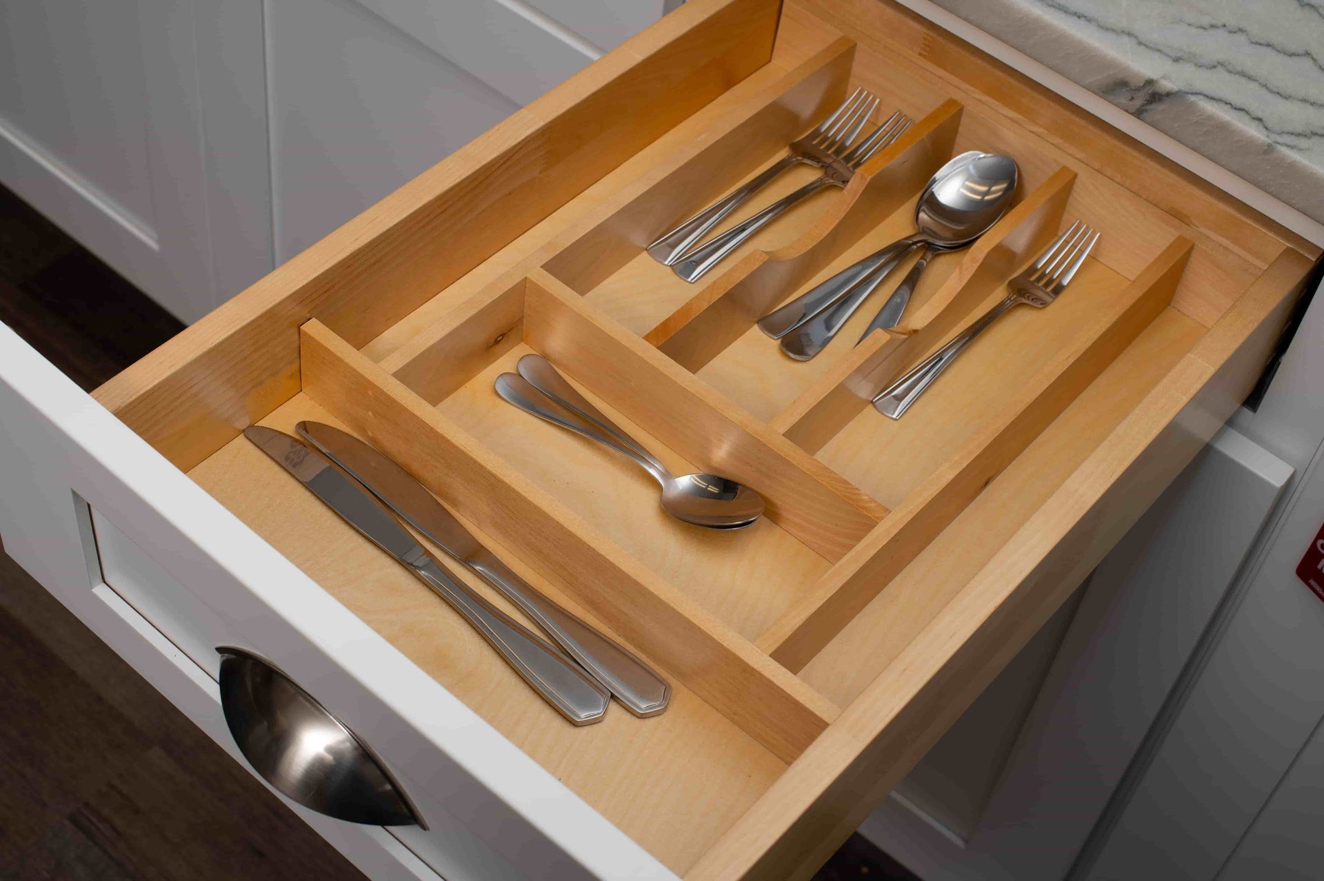 a silver ware drawer divider