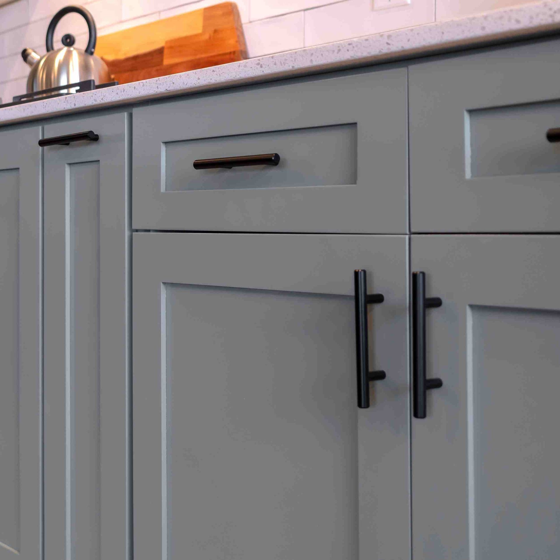 A closeup picture of gray  cabinets