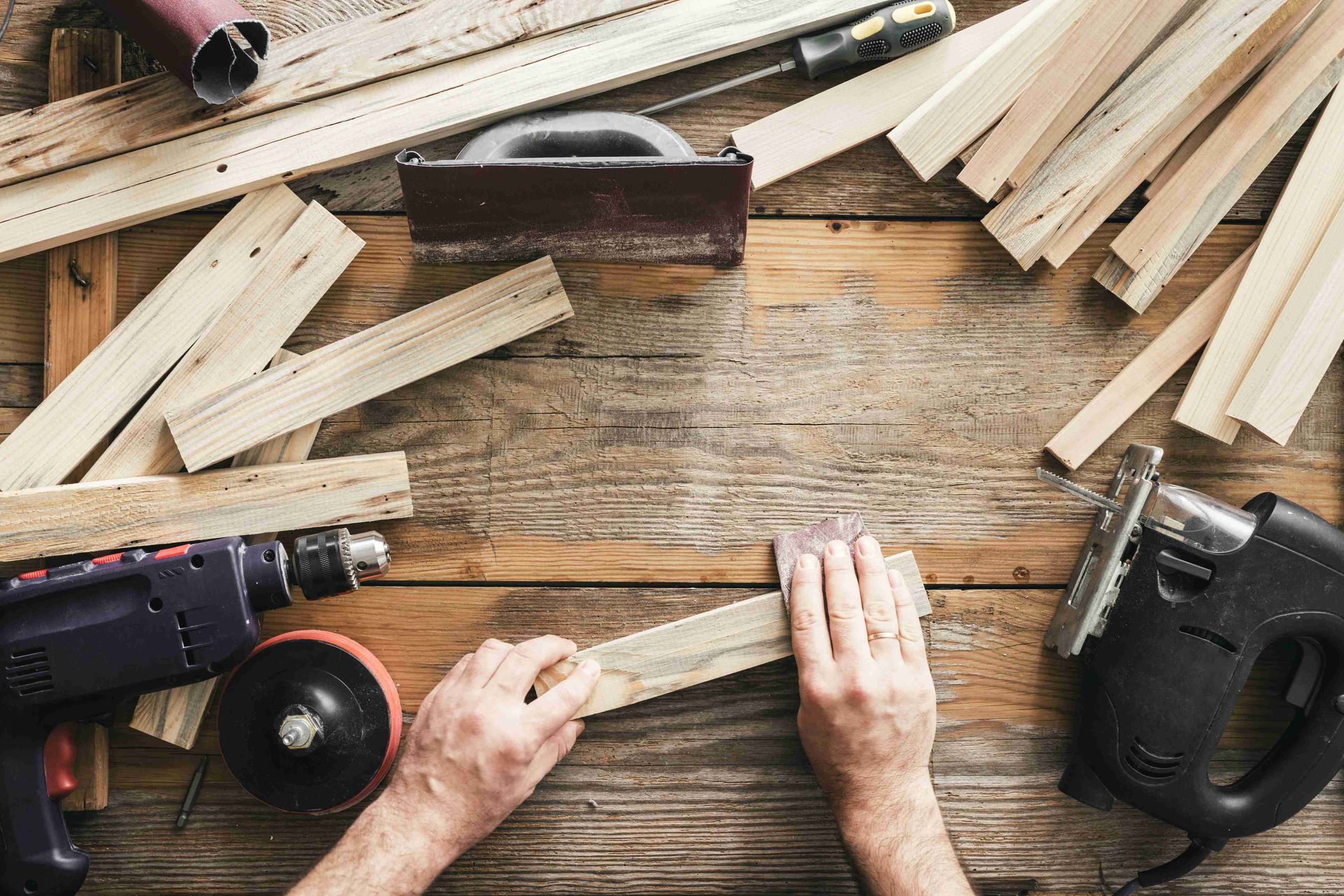 A man assembling cabinetry components