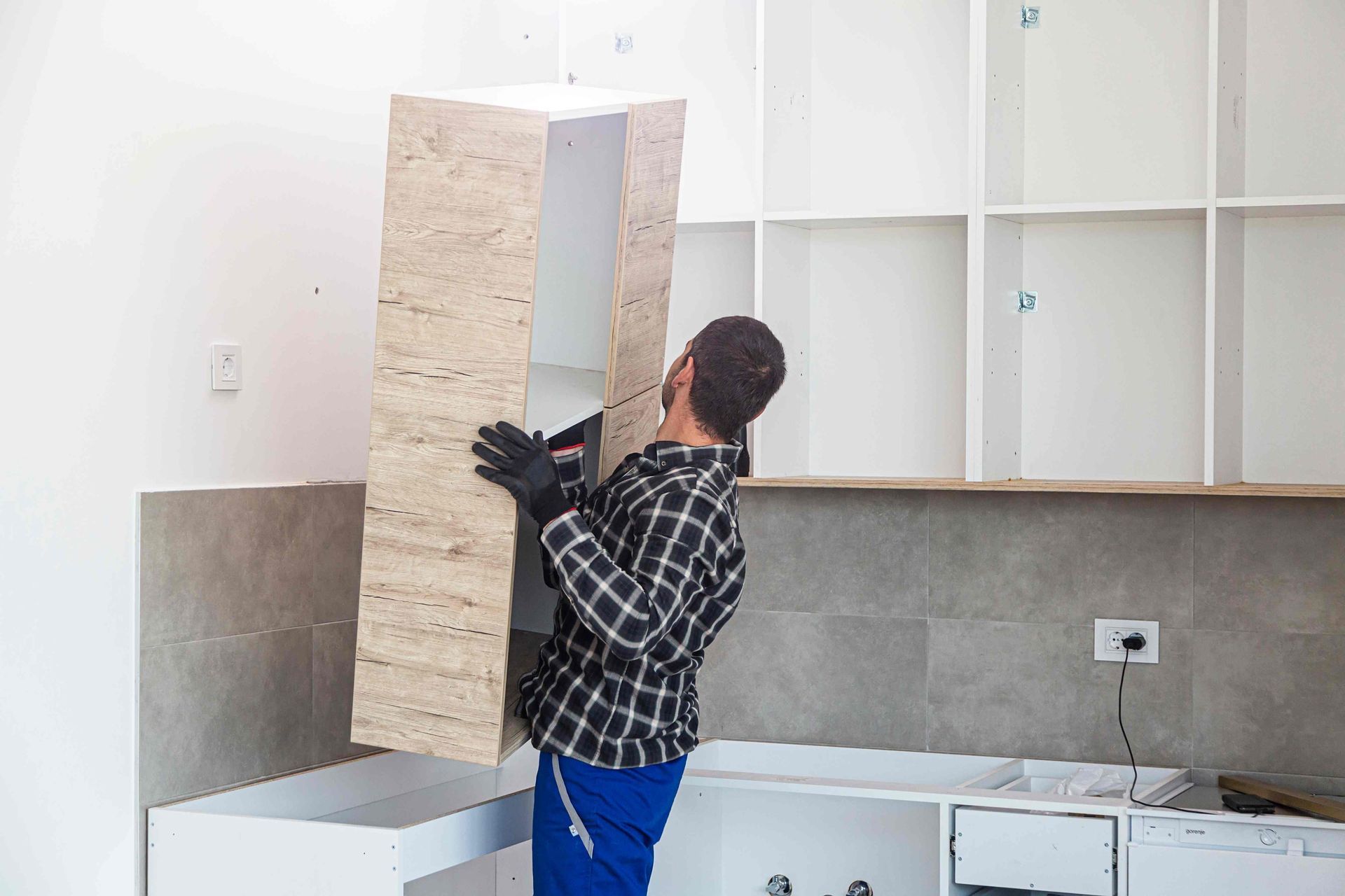Man installing new cabinetry in Windsor home