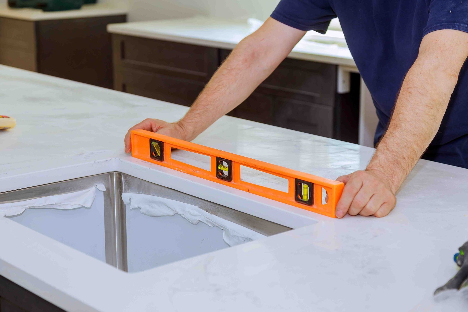 A man installing a countertop from Fort Collins Cabinet Kings