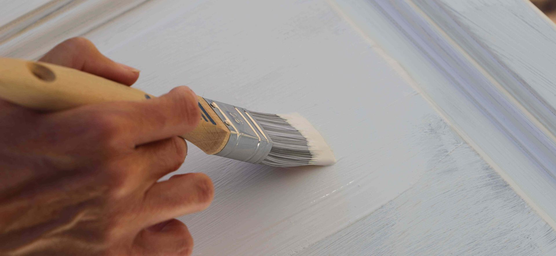 Man painting a cabinet