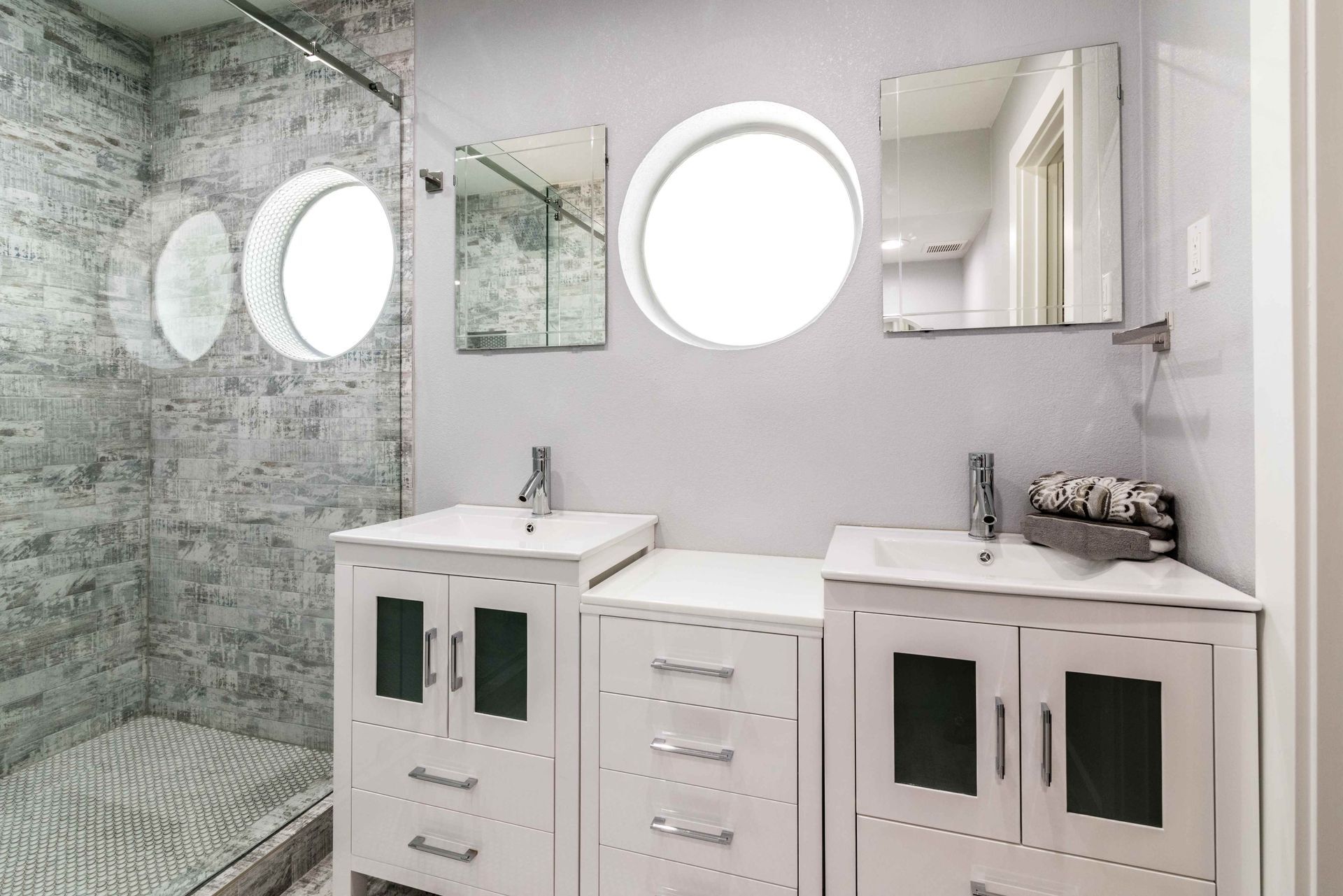 A gorgeous bathroom vanity with nice cabinetry oh the front