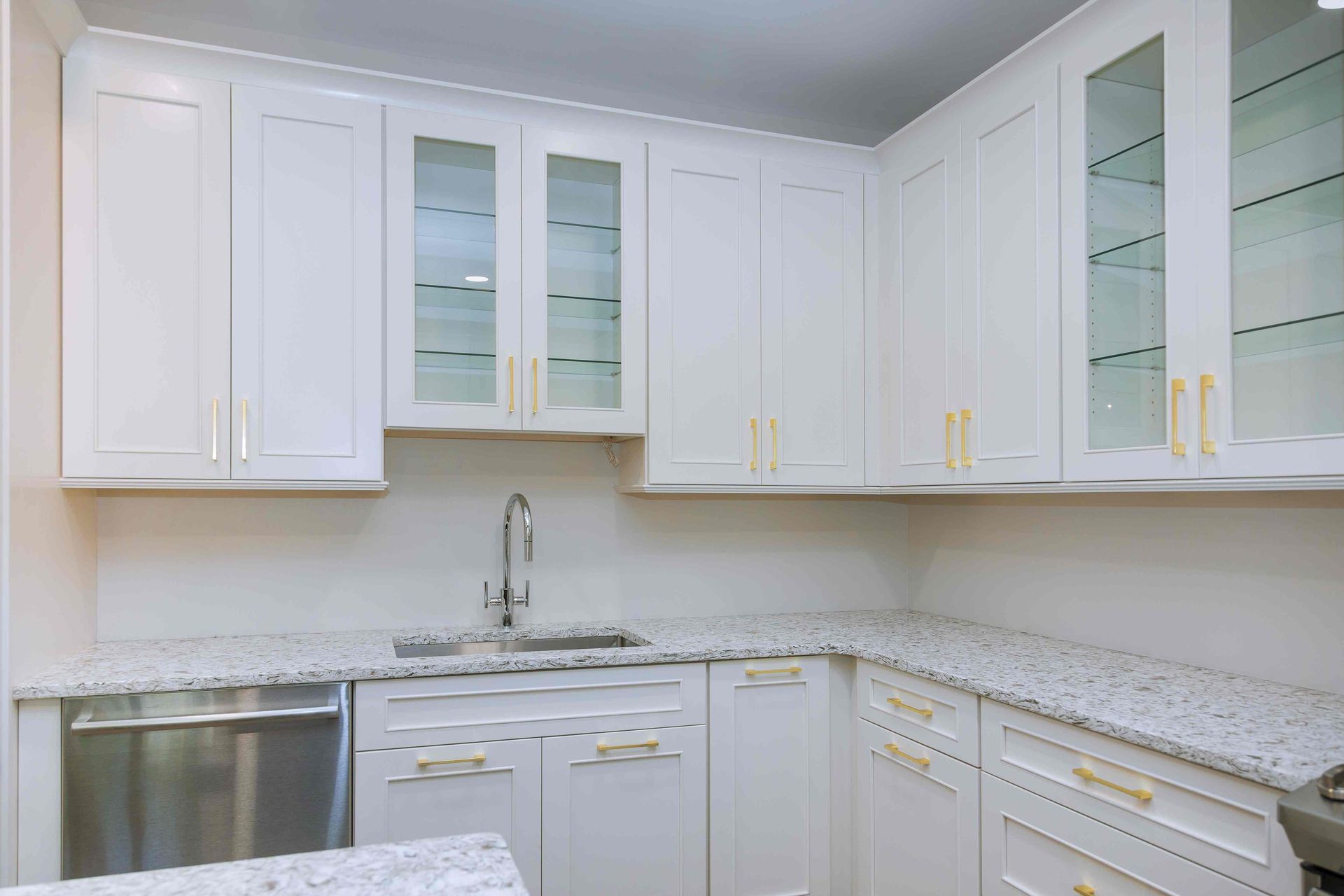 White custom cabinetry with glass fronts