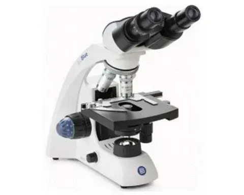 A close up of a microscope on a white background.