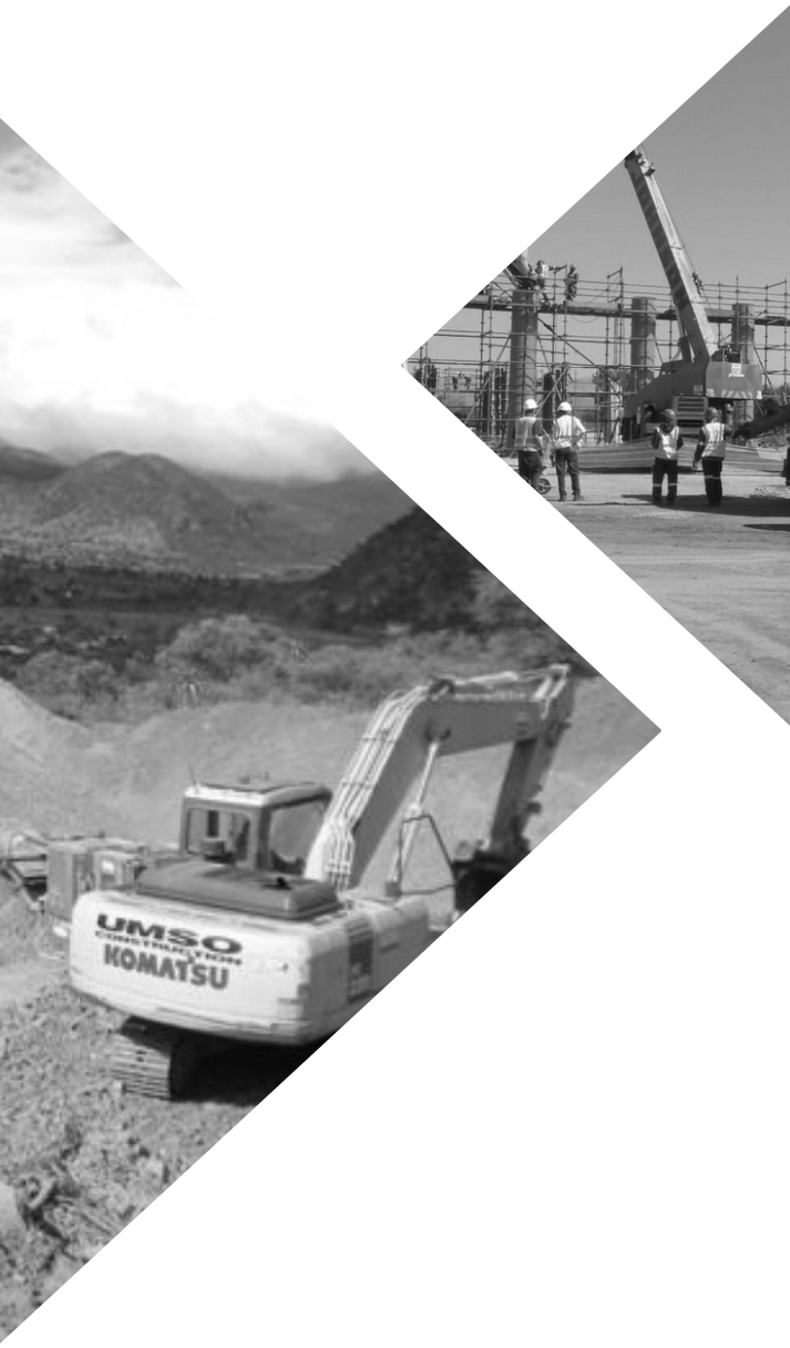 Excavator working at a construction site near a mountain in black and white.