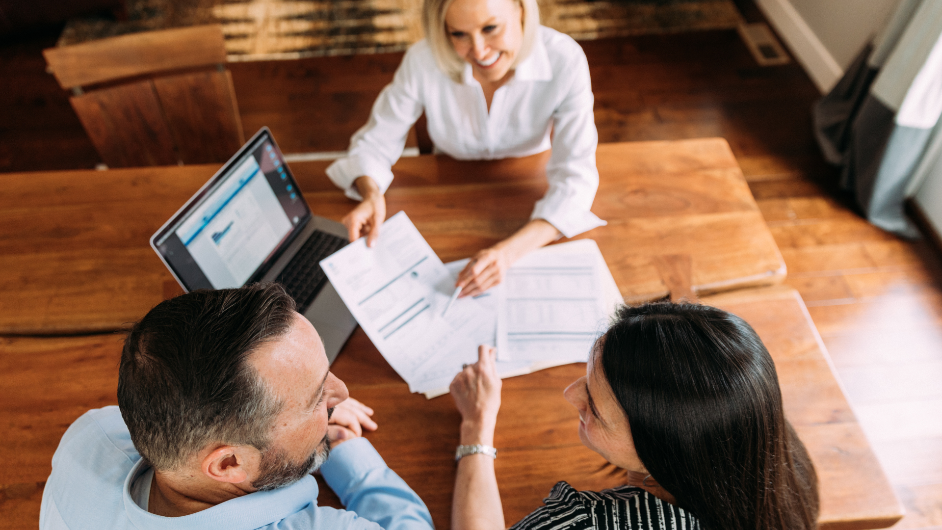 A pile of hundred dollar bills on a table.