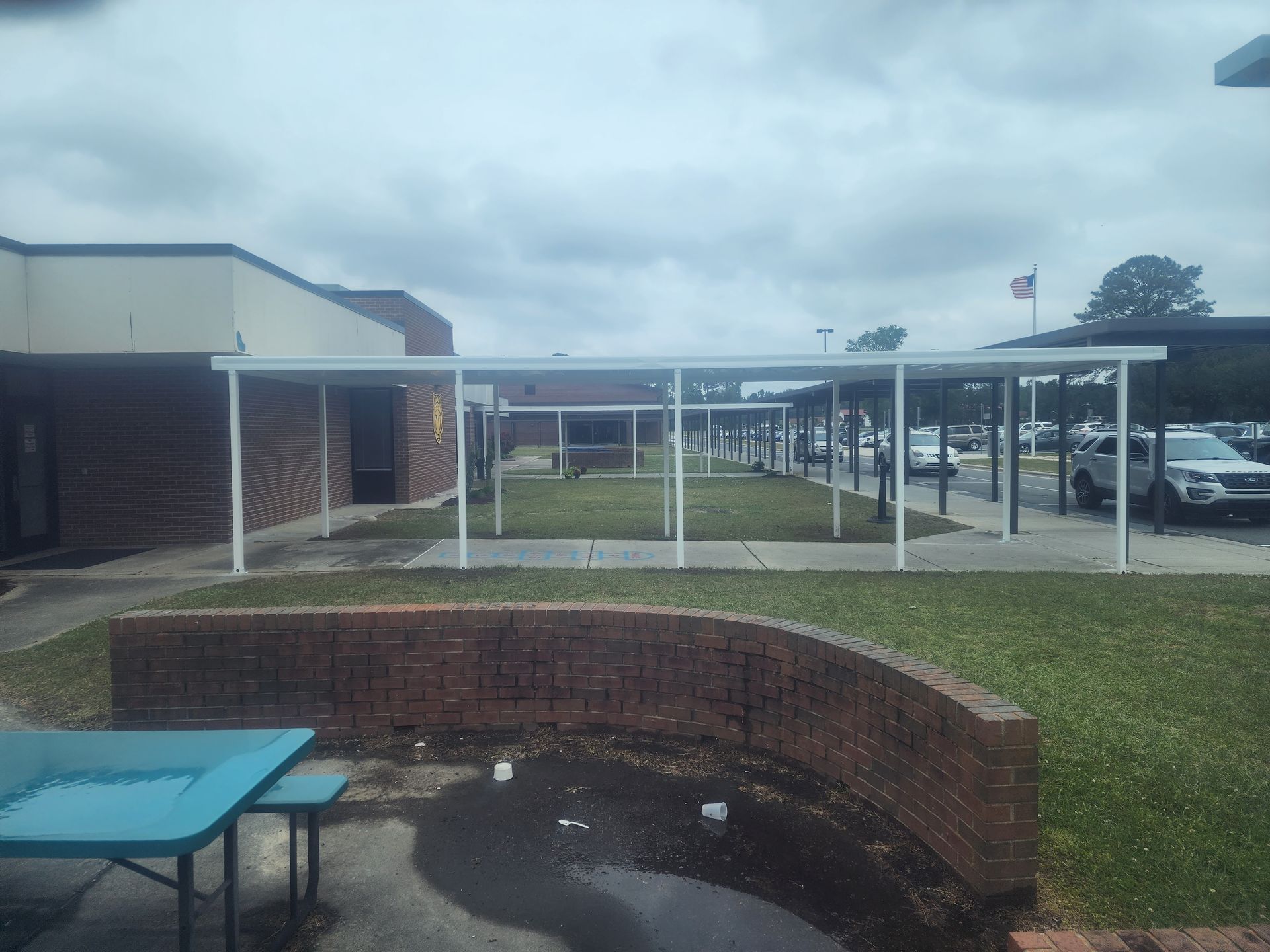 A blue picnic table is in front of a building