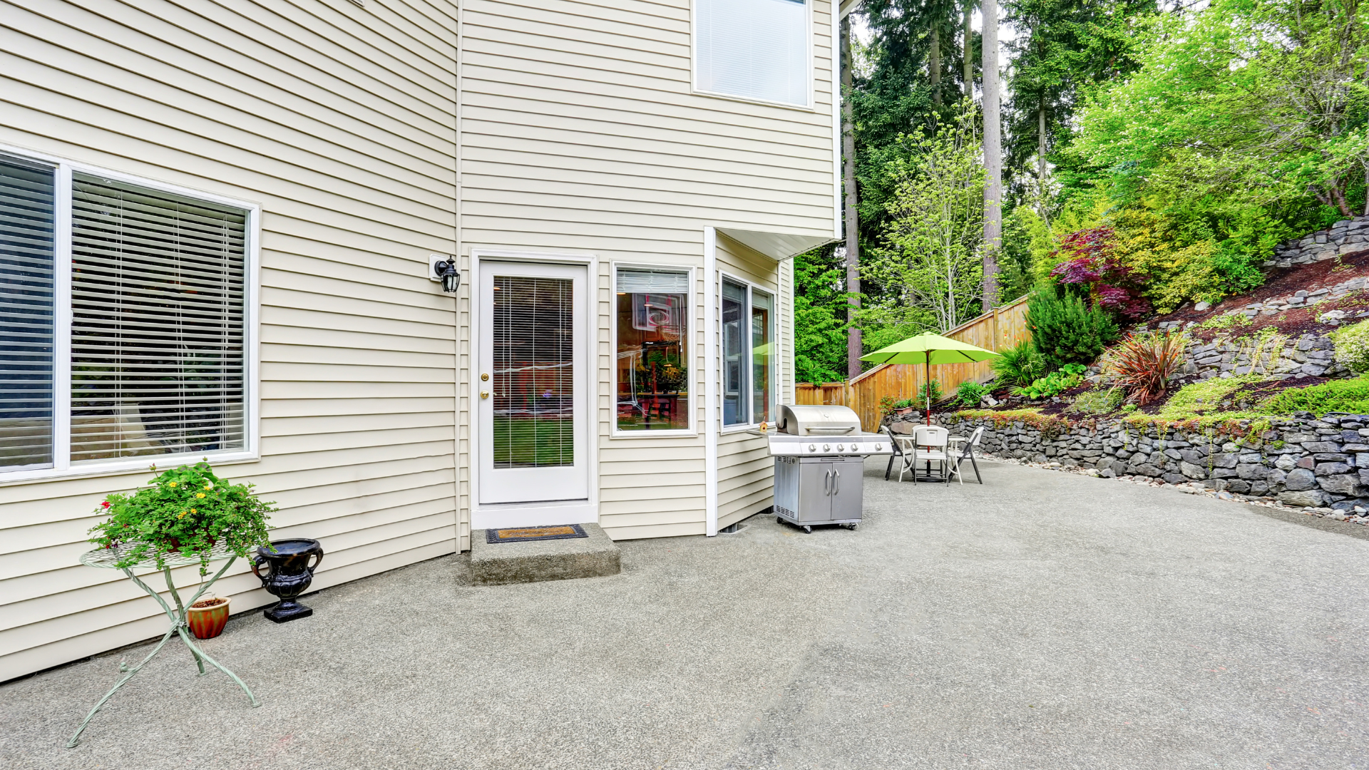 A large white house with a large patio in front of it.