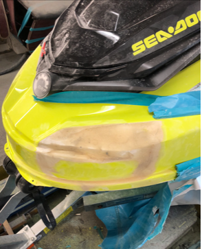 A yellow sea doo jet ski is sitting on a table