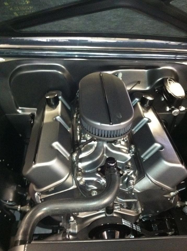 A close up of a car engine with a air filter