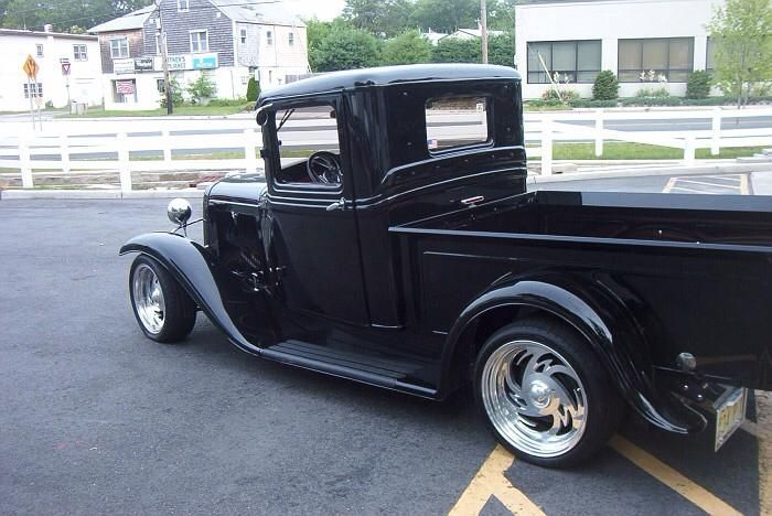 A black truck is parked in a handicapped parking spot