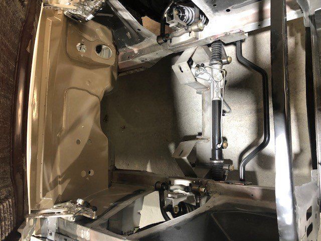 A close up of the inside of a car with a steering wheel.