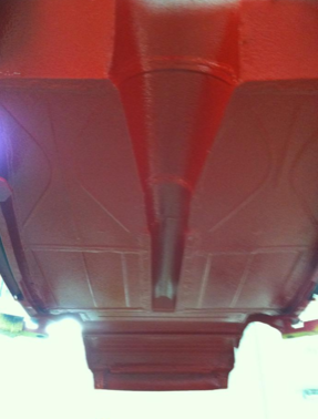 A close up of the bottom of a red car.