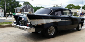 A black car is parked on the side of the road