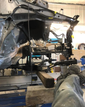 A car is being worked on in a garage