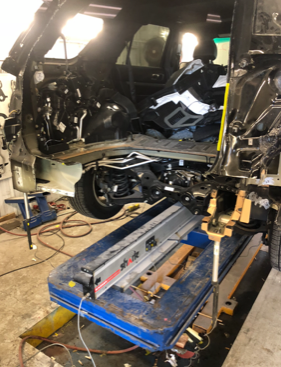A car is being dismantled in a garage
