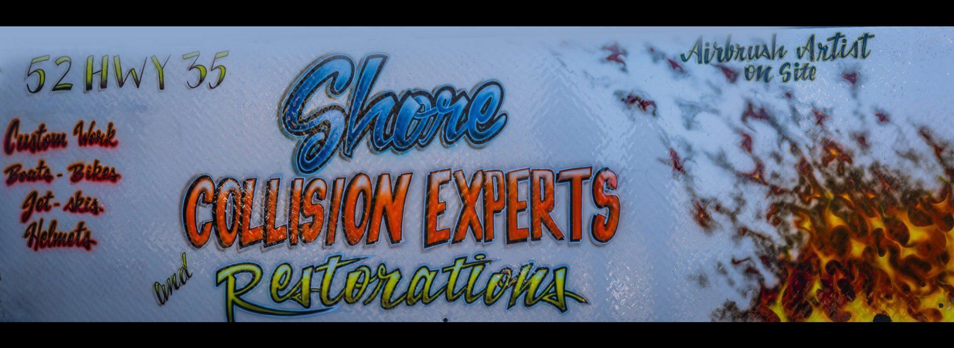 A sign that says collision experts and restorations on it