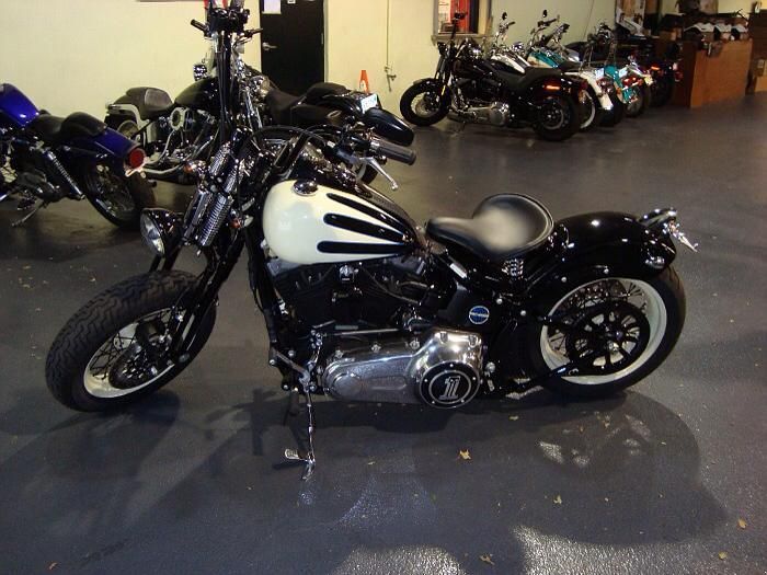 A black and white motorcycle is parked in a garage