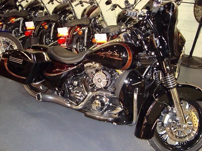 A row of harley davidson motorcycles are lined up in a showroom