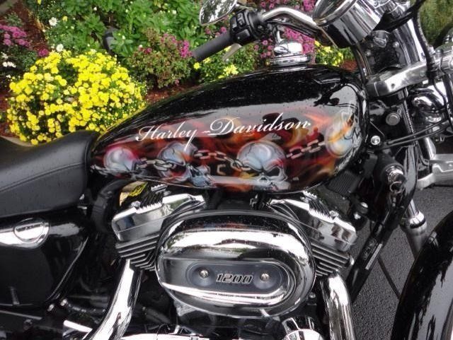 A harley davidson motorcycle is parked in front of flowers
