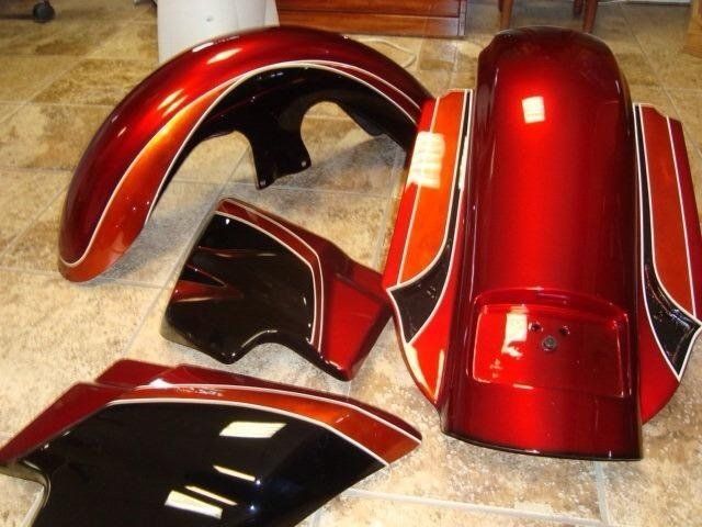A red and black motorcycle is sitting on a tiled floor