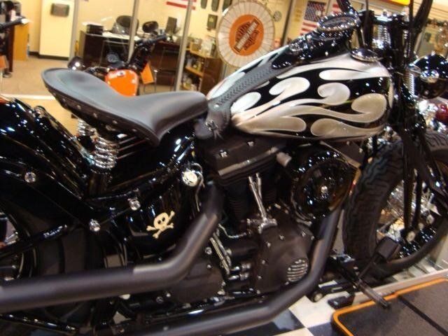 A harley davidson motorcycle with flames painted on the tank