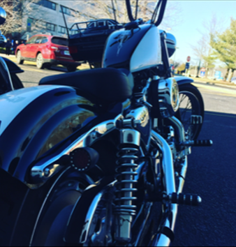 A black and white motorcycle is parked on the side of the road