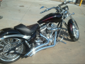 A black motorcycle is parked on the side of the road