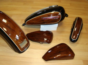 A set of wooden motorcycle parts on a wooden table