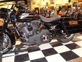 A black harley davidson motorcycle is parked on a checkered floor