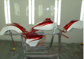 A red and white motorcycle is sitting on a cart