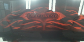 A harley davidson laptop with red flames painted on it
