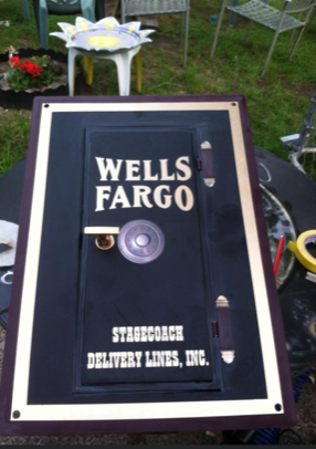 A wells fargo safe sits on a table outside