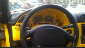 A yellow car with a black steering wheel
