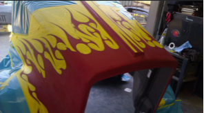 A red and yellow item with flames painted on it