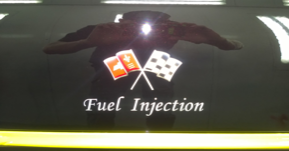 A fuel injection logo is on the back of a car