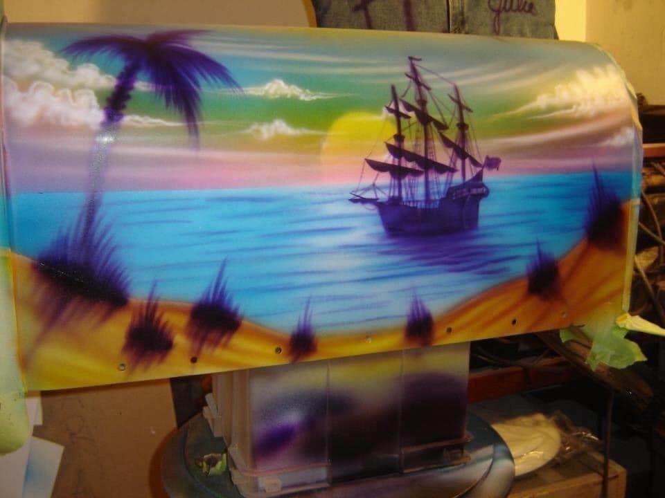 A painting of a ship in the ocean on a mailbox