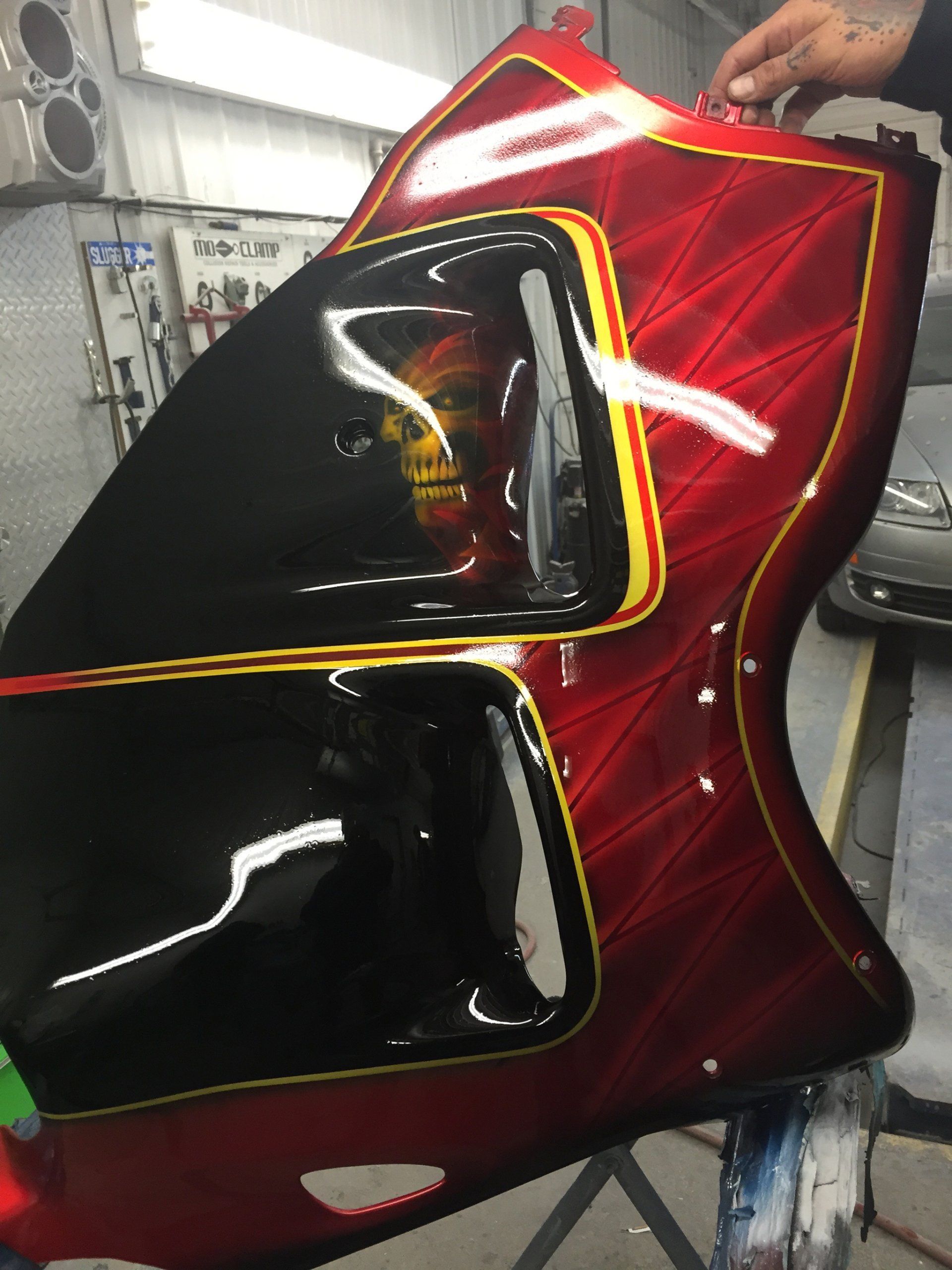 A red and black motorcycle with a skull painted on it