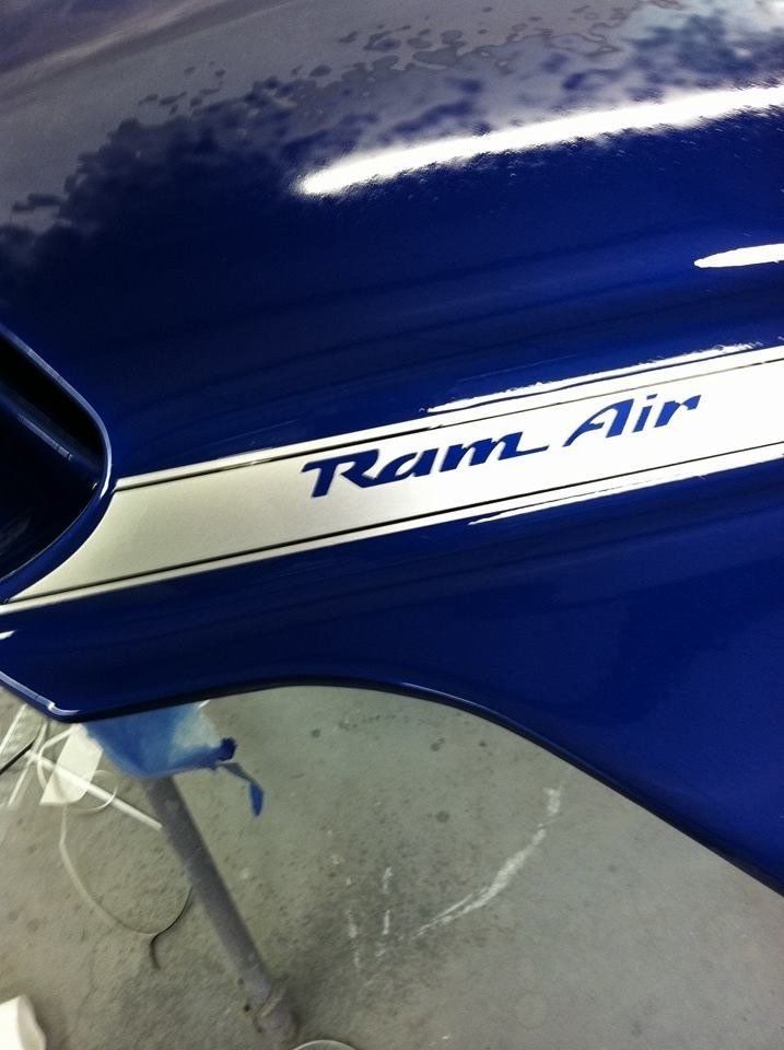 A blue car with a ram air sticker on it