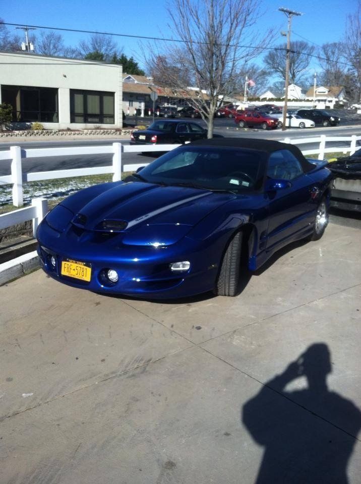 A blue sports car is parked in a parking lot