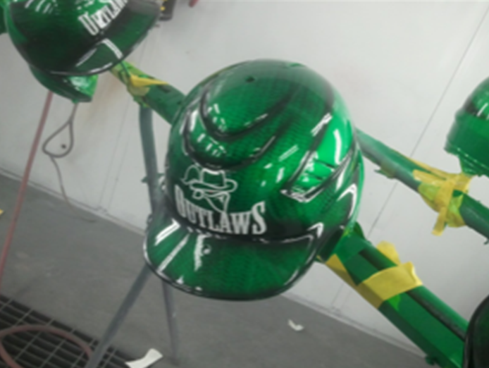A green helmet with the word outlaws on it