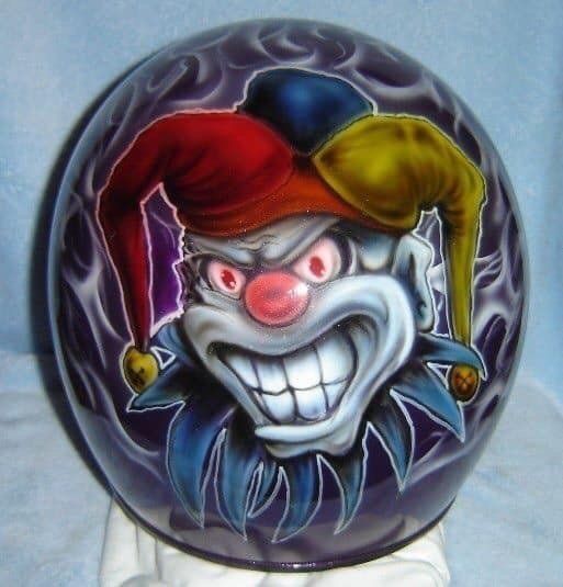 A purple ball with a clown face on it