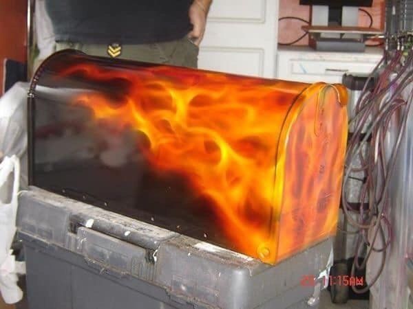A mailbox with flames painted on it